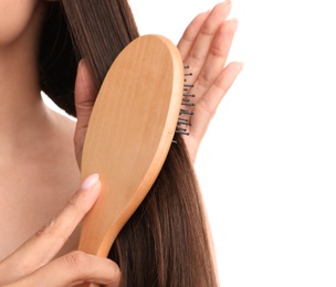 Woman with hair brush on white background, closeup