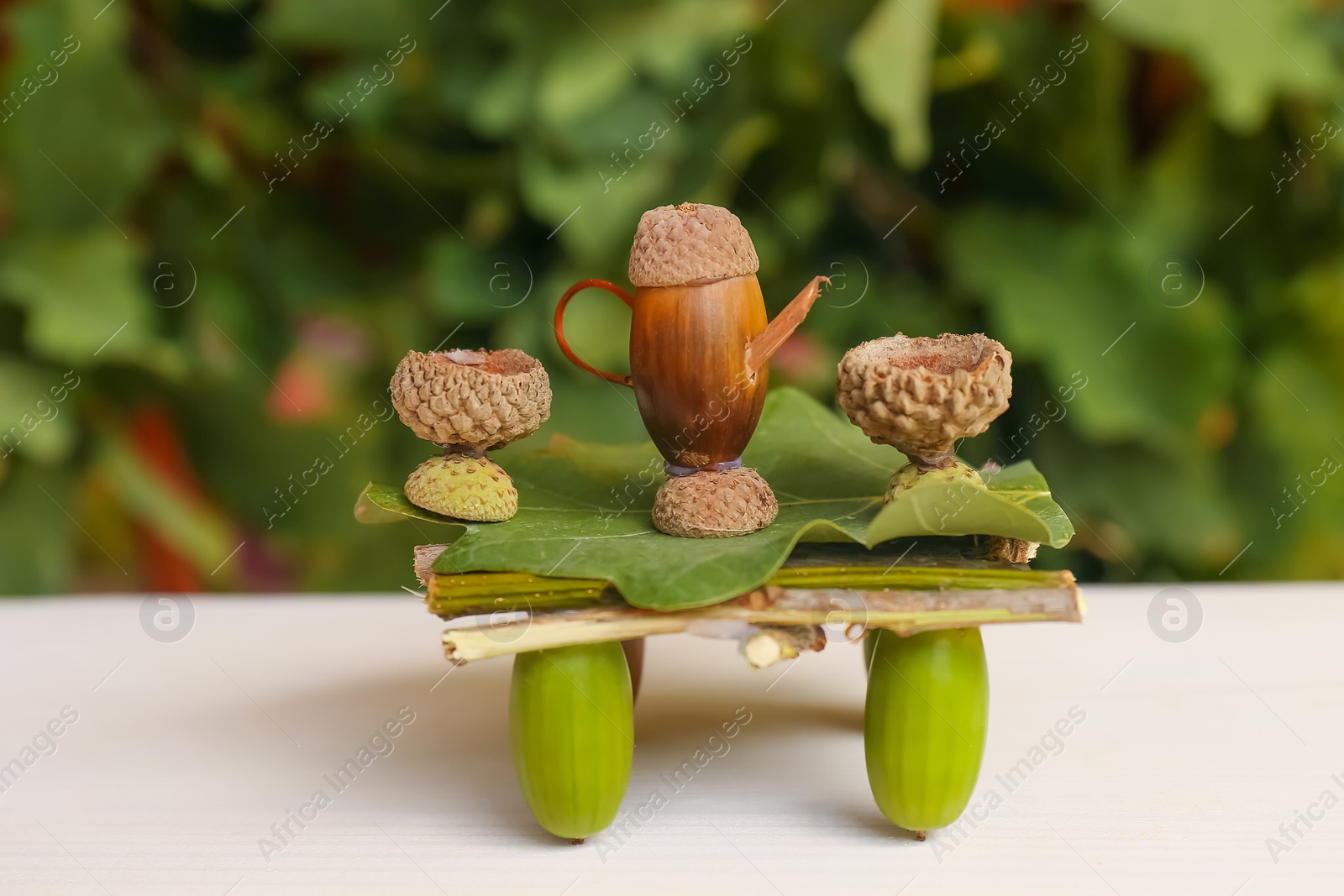 Photo of Tea set composition made of natural materials on white wooden table
