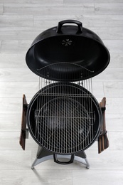 New modern barbecue grill on wooden floor