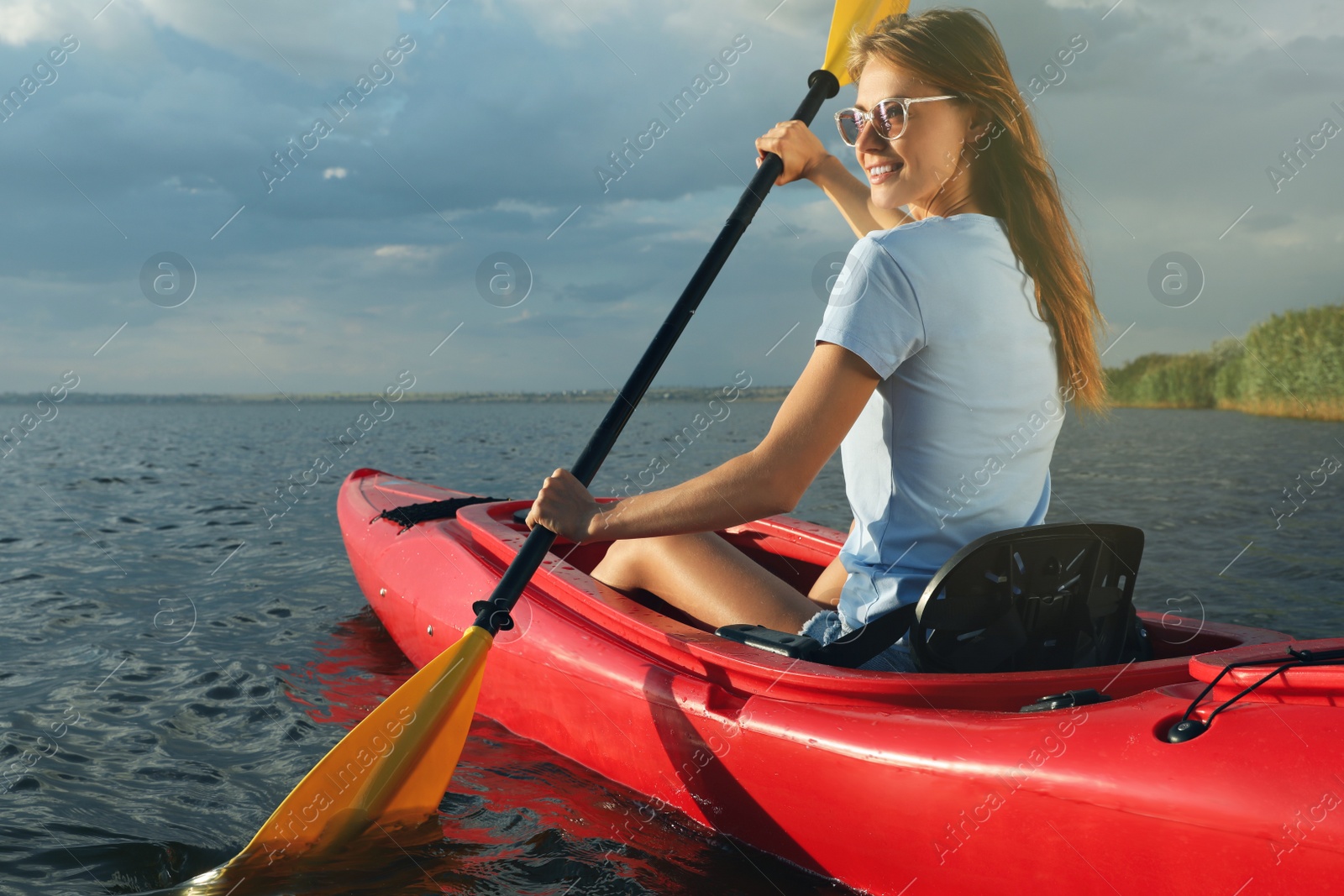 Photo of Happy woman kayaking on river. Summer activity