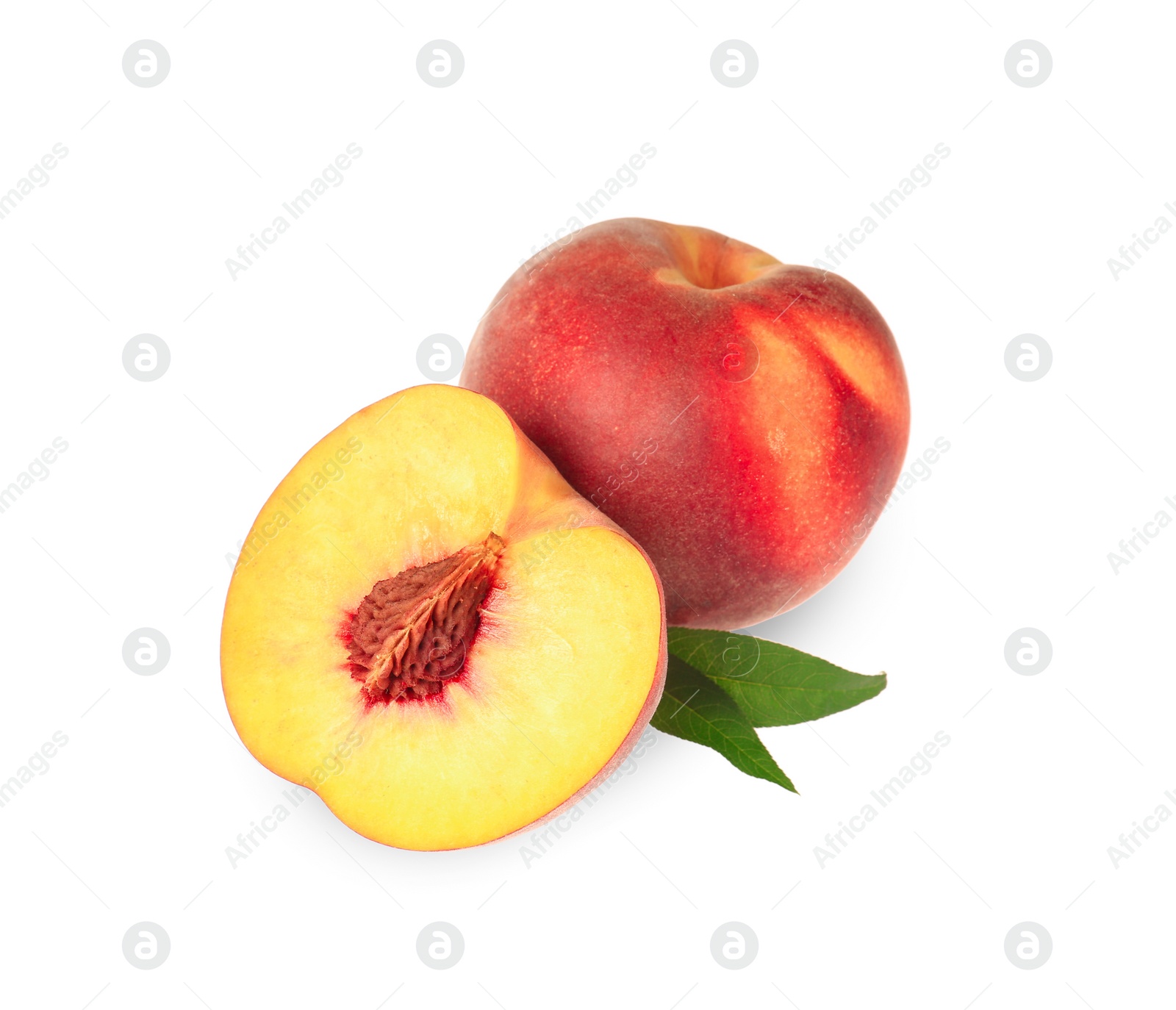 Photo of Whole and cut delicious peaches with green leaves isolated on white