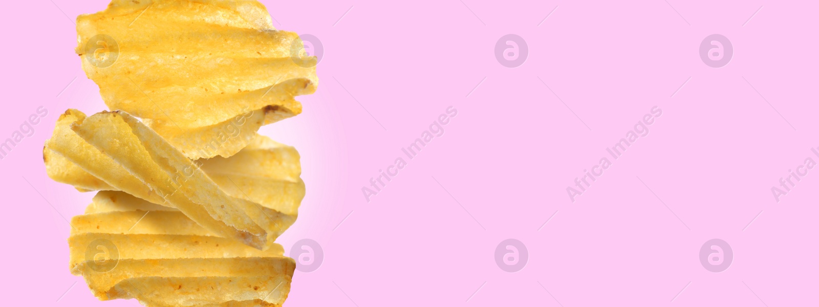 Image of Stack of tasty ridged potato chips on light violet background, space for text