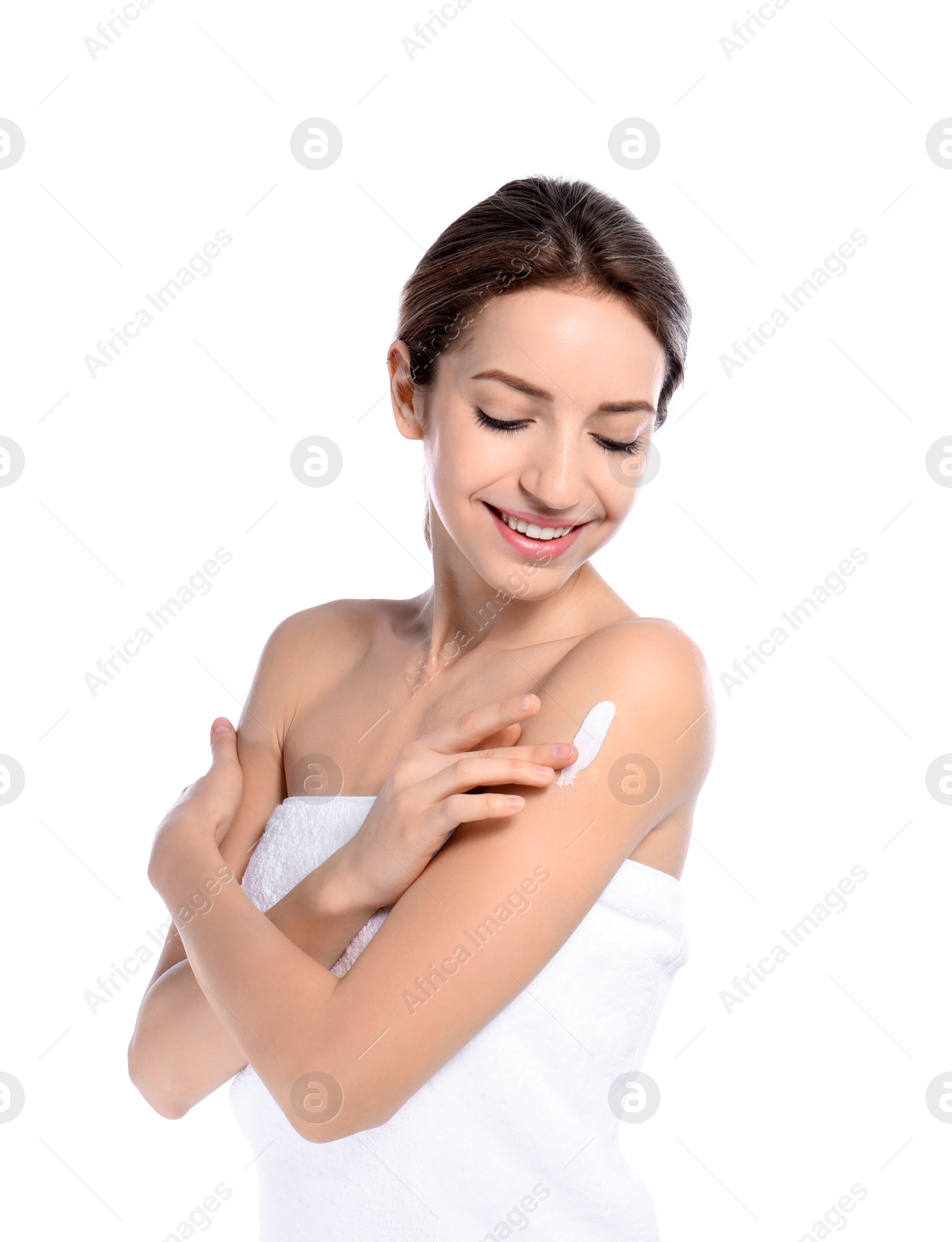 Photo of Young woman applying cream on white background. Beauty and body care