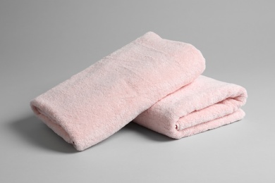 Photo of Fresh soft folded towels on light background