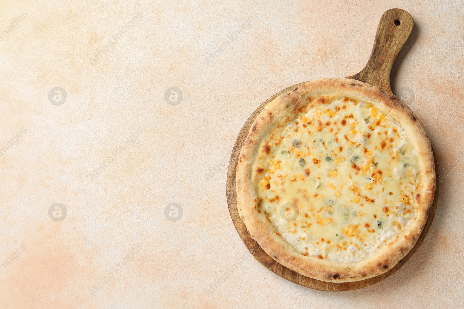 Photo of Delicious cheese pizza on beige textured table, top view. Space for text