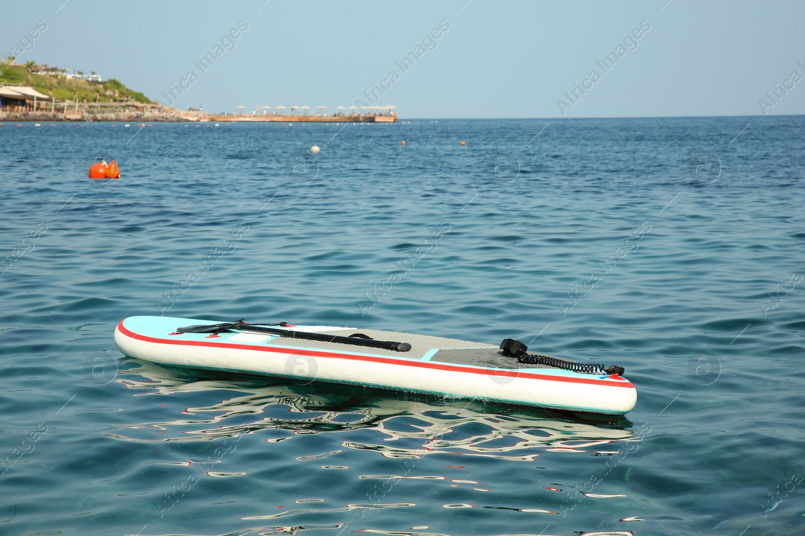 Photo of One SUP board with paddle on sea water