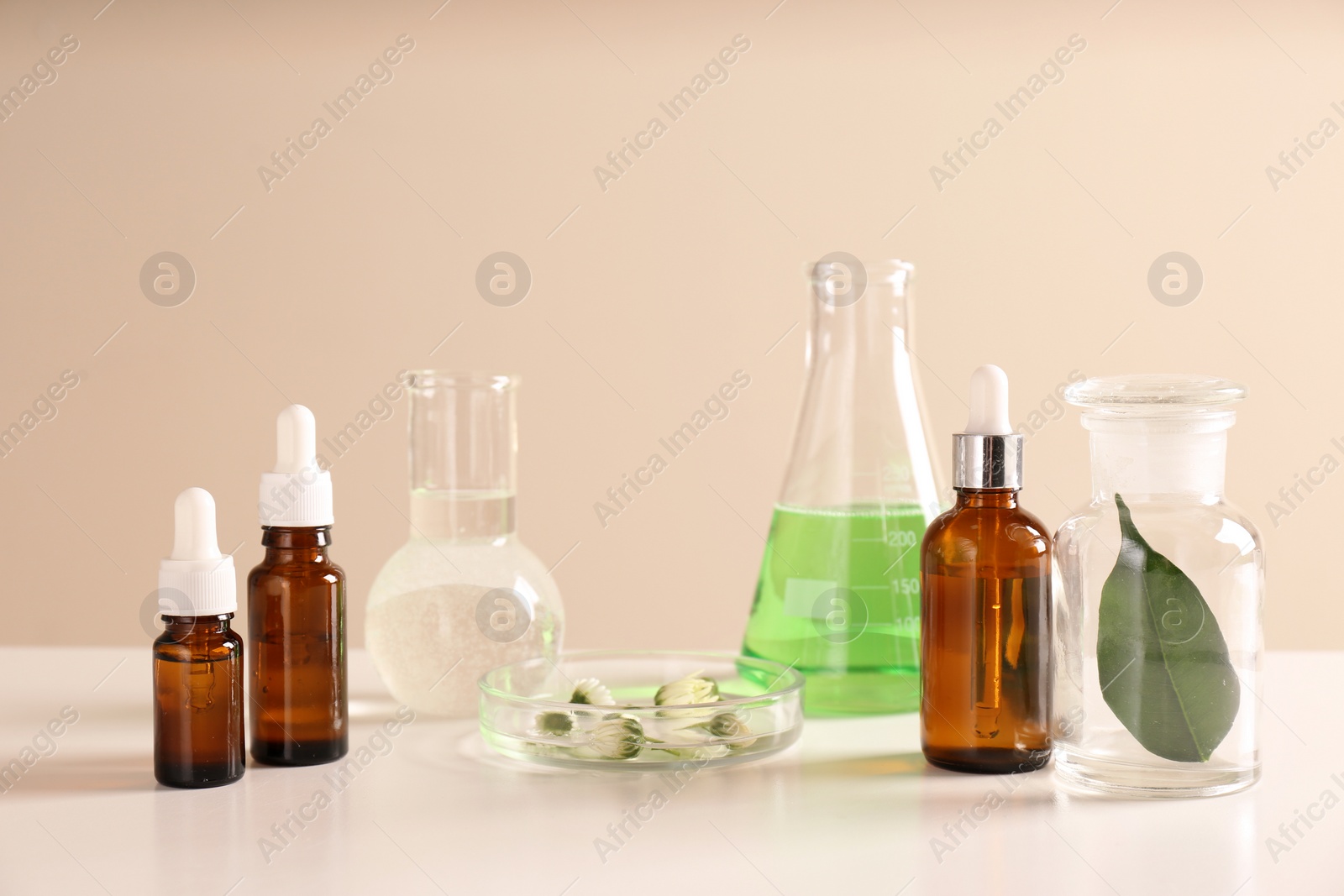 Photo of Skin care products, ingredients and laboratory glassware on table. Dermatology research