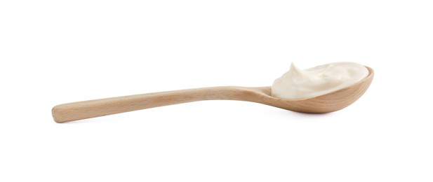 Photo of One wooden spoon with mayonnaise isolated on white