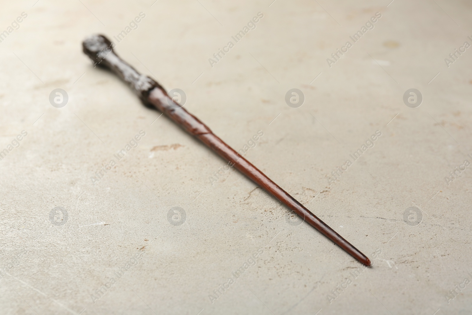 Photo of One magic wand on light textured background, closeup