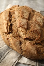 Freshly baked sourdough bread and napkin on table