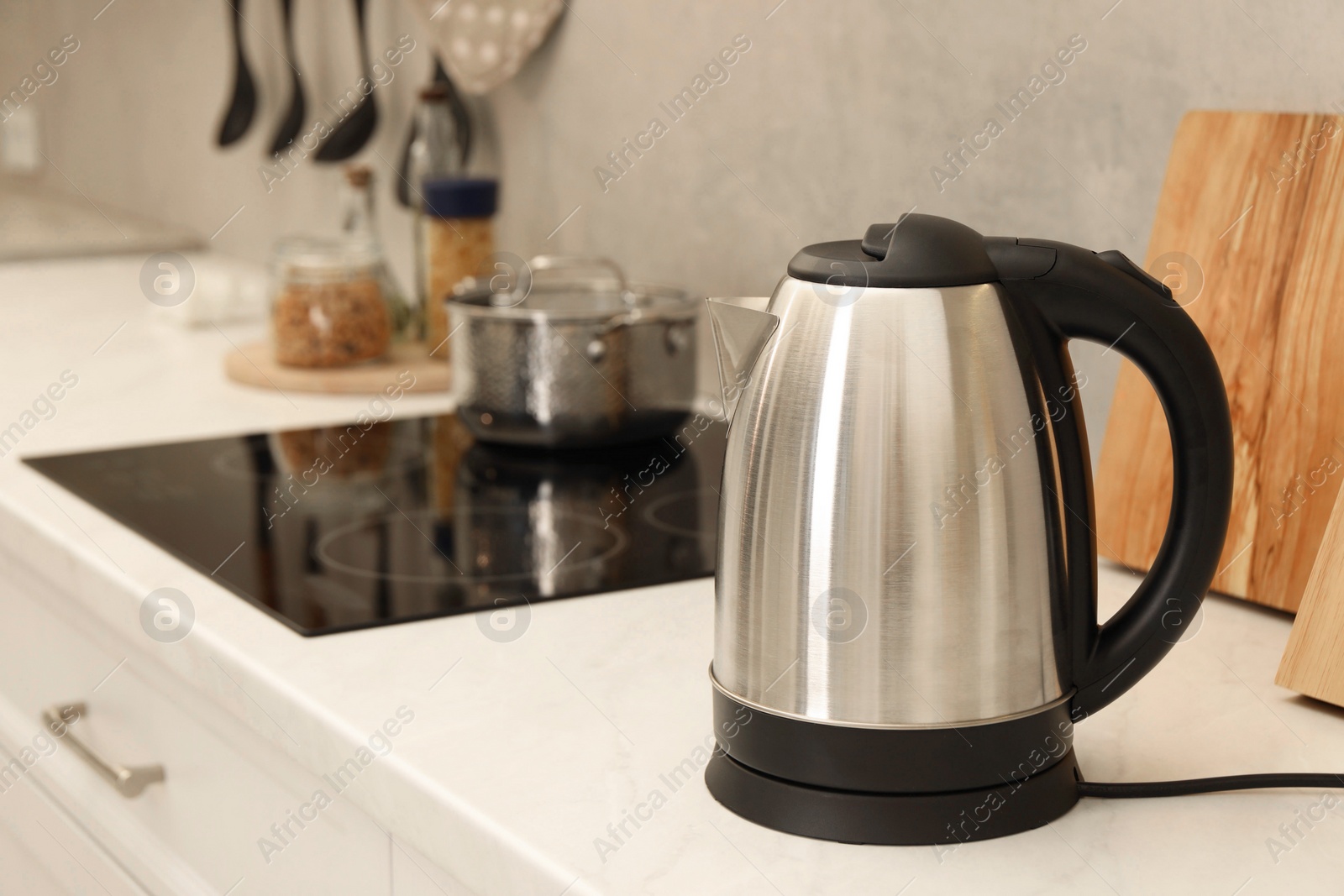 Photo of Modern electric kettle on counter in kitchen