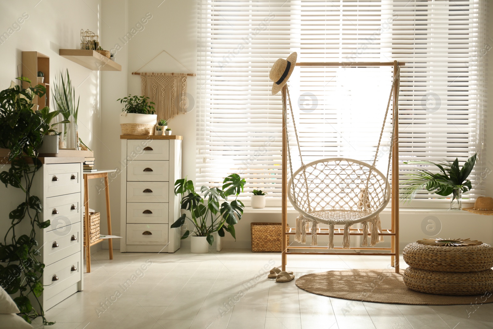 Photo of Comfortable hammock chair in stylish room. Interior design