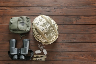 Set of military outfit on wooden background, flat lay