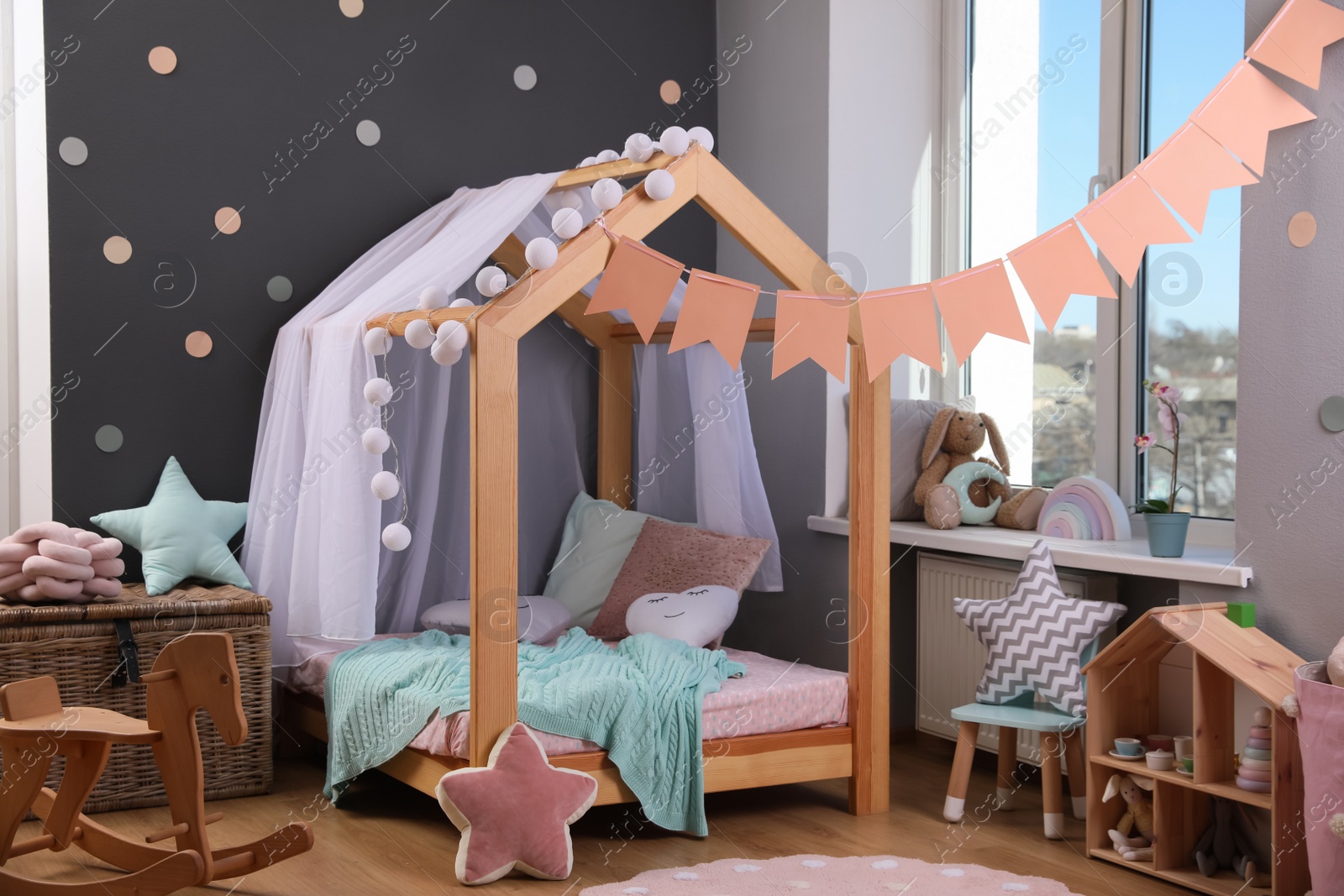 Photo of Stylish child room interior with house bed and different toys