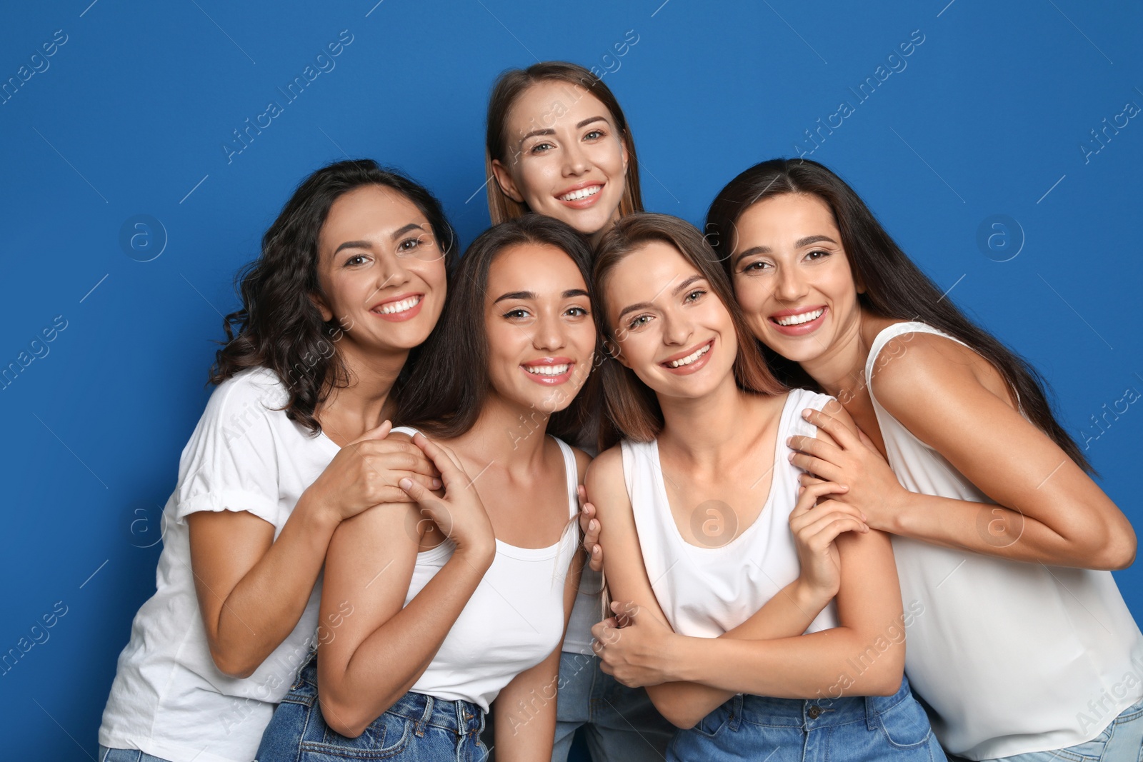 Photo of Happy women on blue background. Girl power concept