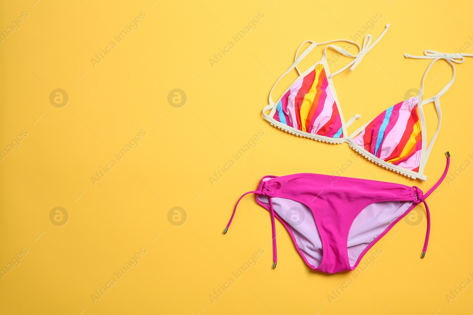 Photo of Stylish bikini on color background, top view