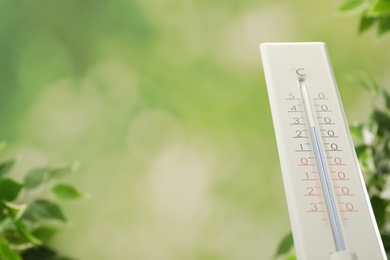 Photo of Weather thermometer on blurred background, closeup. Space for text