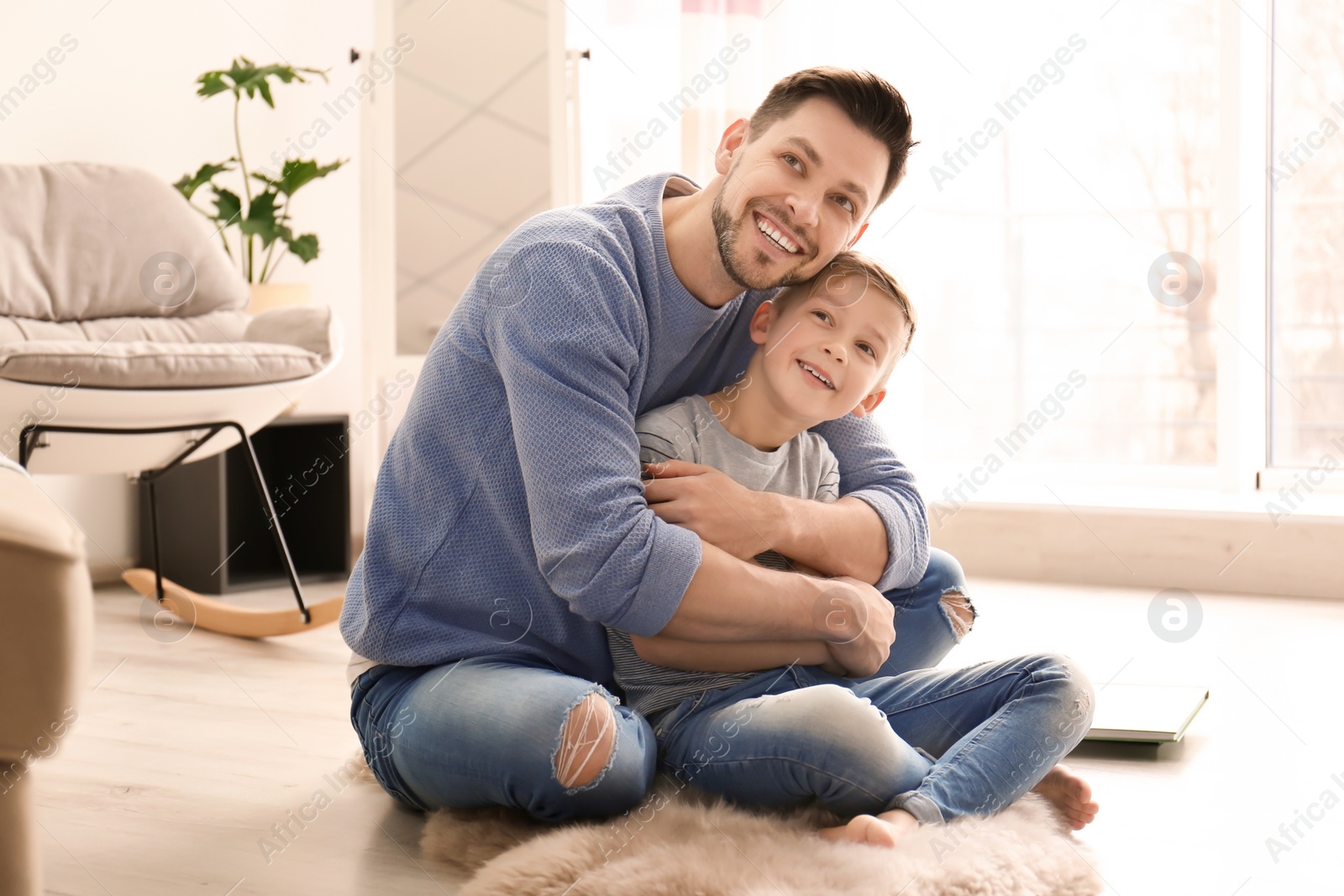 Photo of Little boy and his dad spending time together at home