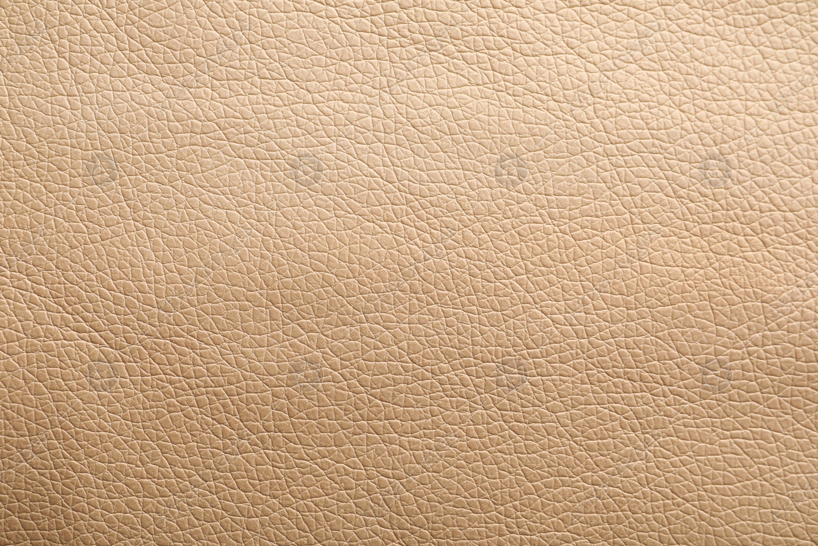 Photo of Texture of beige leather as background, closeup