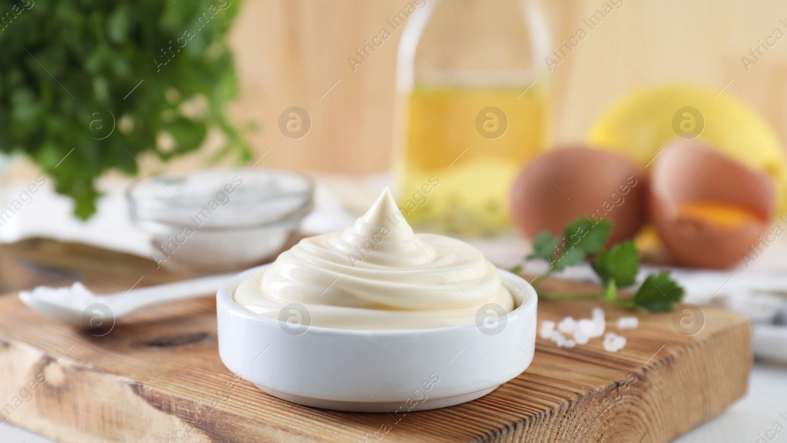 Photo of Fresh mayonnaise sauce in bowl on table