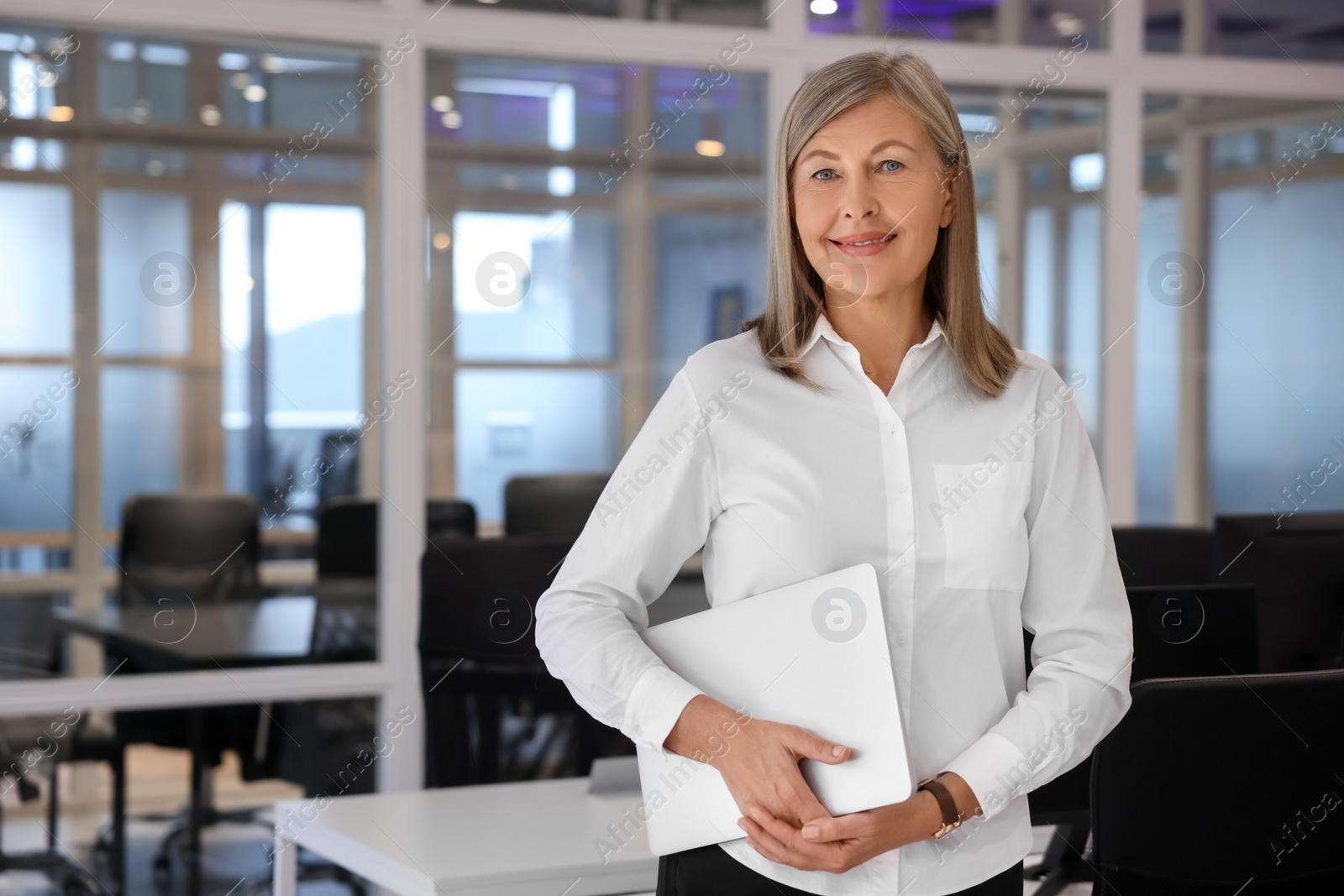 Photo of Smiling woman with laptop in office, space for text. Lawyer, businesswoman, accountant or manager