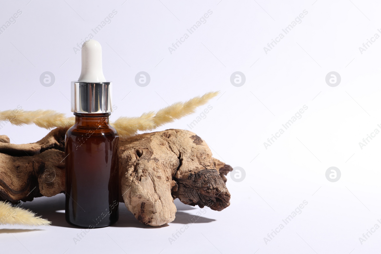 Photo of Composition with bottle of cosmetic serum on white background. Space for text