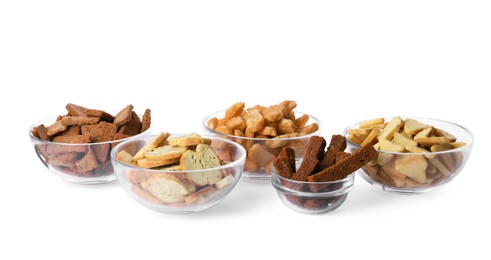 Photo of Different crispy rusks in bowls on white background