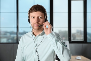 Photo of Male technical support operator with headset in office