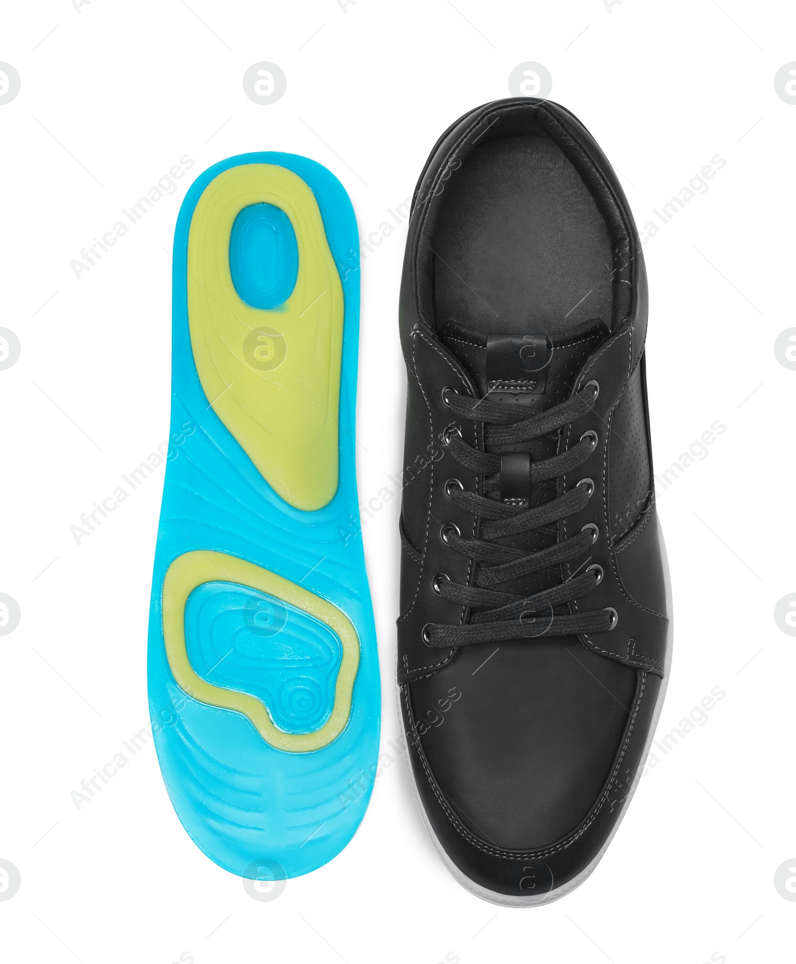 Photo of Orthopedic insole near shoe on white background, top view