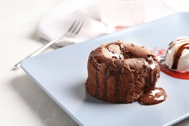 Plate of delicious fresh fondant with hot chocolate and ice cream on table. Lava cake recipe