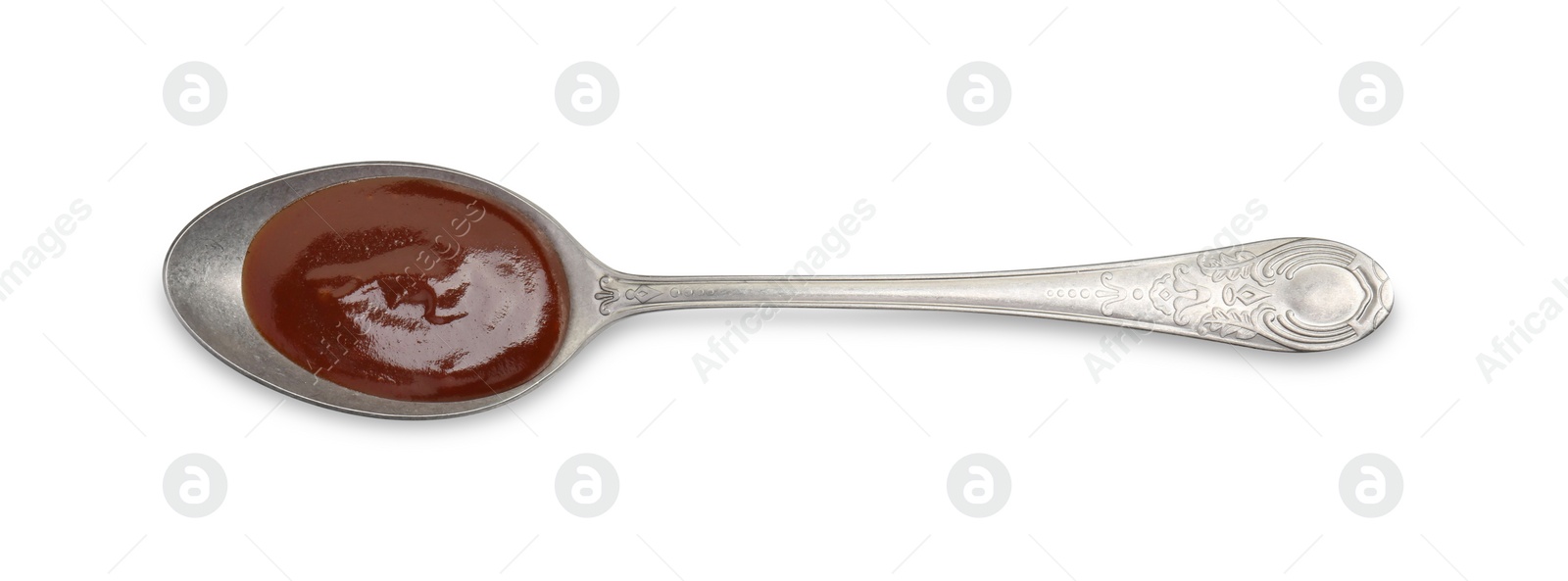 Photo of Tasty barbecue sauce in spoon isolated on white, top view