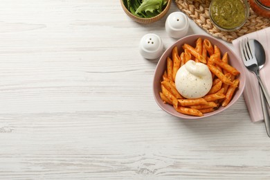 Photo of Bowl of delicious pasta with burrata and tomato sauce served on white wooden table, flat lay. Space for text