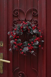 Beautiful Christmas wreath hanging on red door