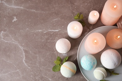 Photo of Flat lay composition with bath bombs, candles and mint leaves on table. Space for text