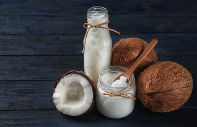 Photo of Fresh coconut oil on dark wooden table. Cooking ingredient