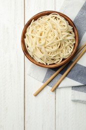 Tasty rice noodles on white wooden table, flat lay