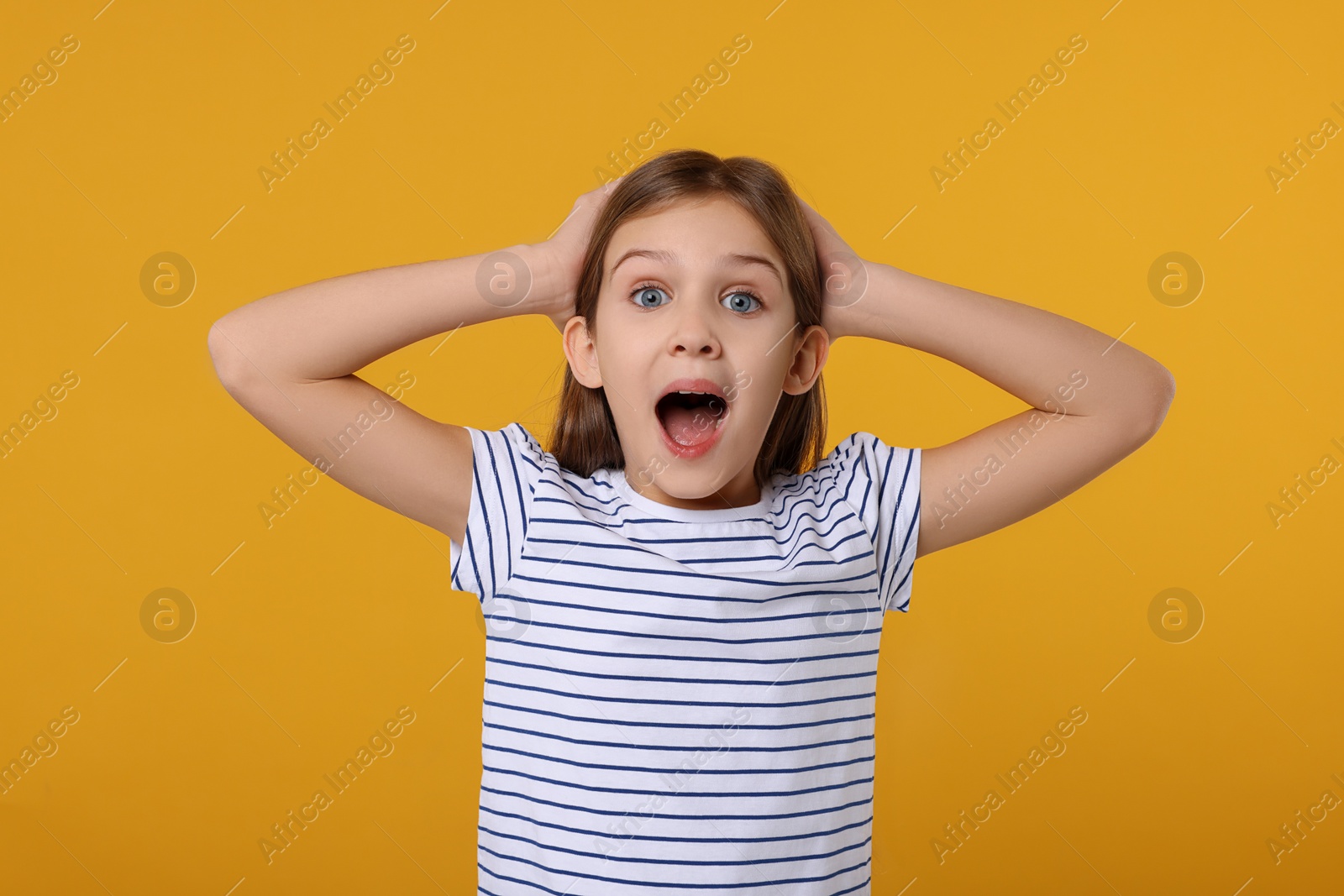 Photo of Portrait of surprised girl on yellow background