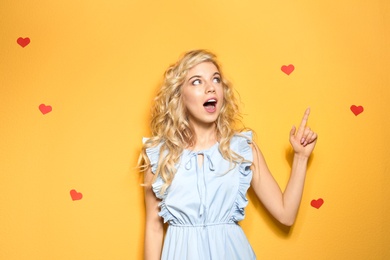 Photo of Emotional stylish young woman on color background