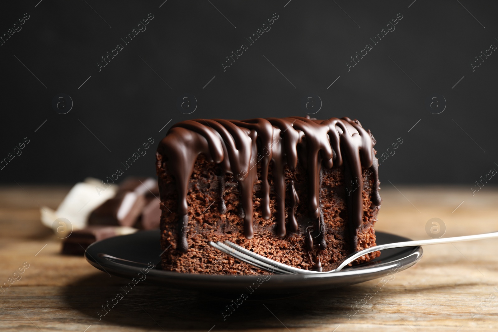 Photo of Tasty chocolate cake served on wooden table