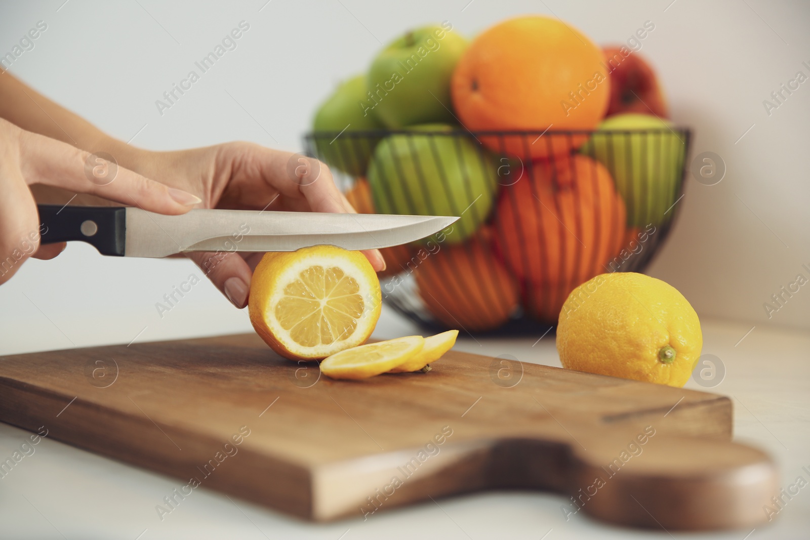 Photo of Woman cooking at table in kitchen, closeup