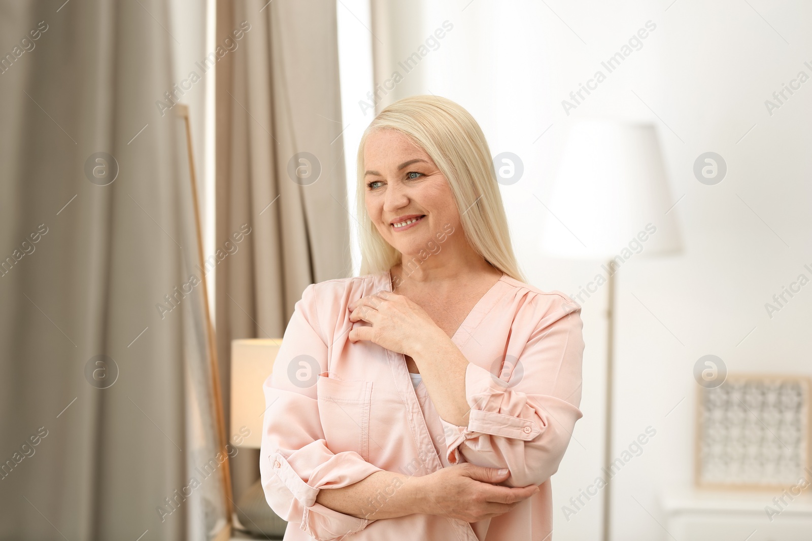 Photo of Portrait of happy mature woman at home