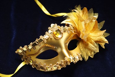 Theater arts. Golden venetian carnival mask on blue fabric