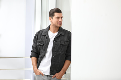 Photo of Handsome man wearing casual outfit near window at home