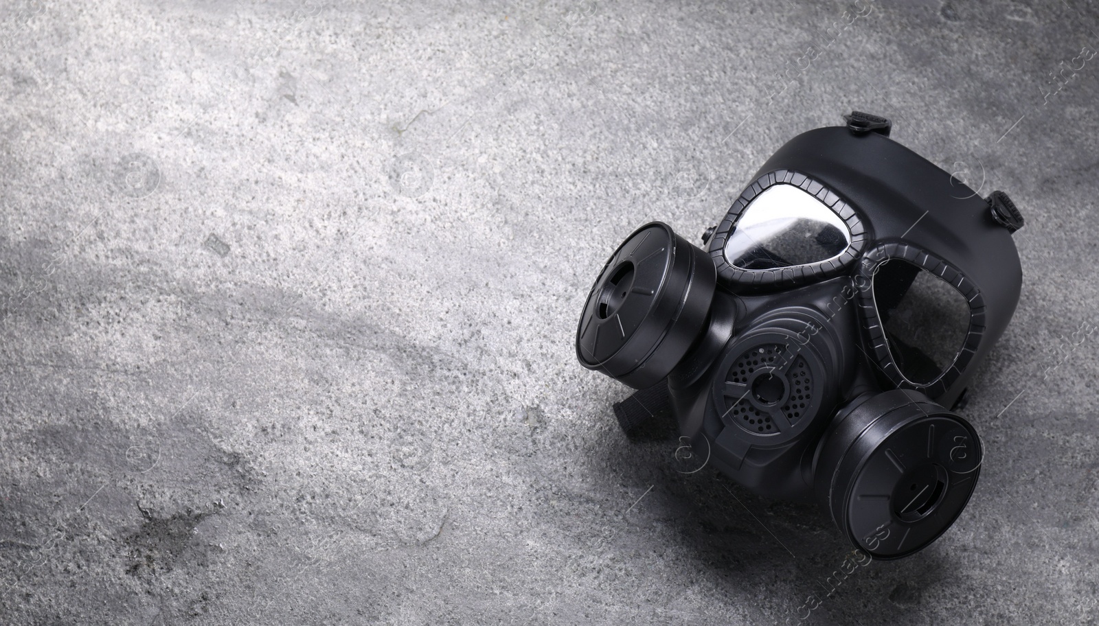 Photo of One gas mask on grey textured background, top view. Space for text