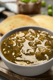 Photo of Delicious gooseberry jam in bowl closeup view