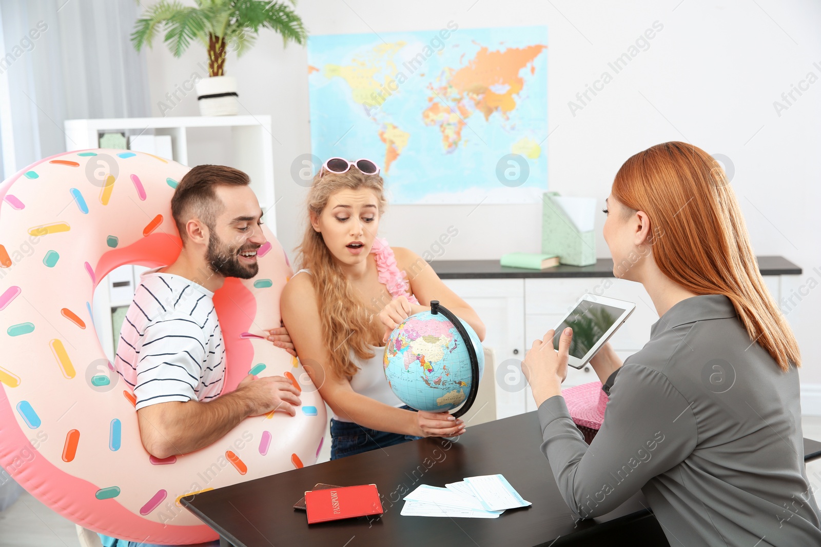 Photo of Beautiful young couple visiting travel agency office