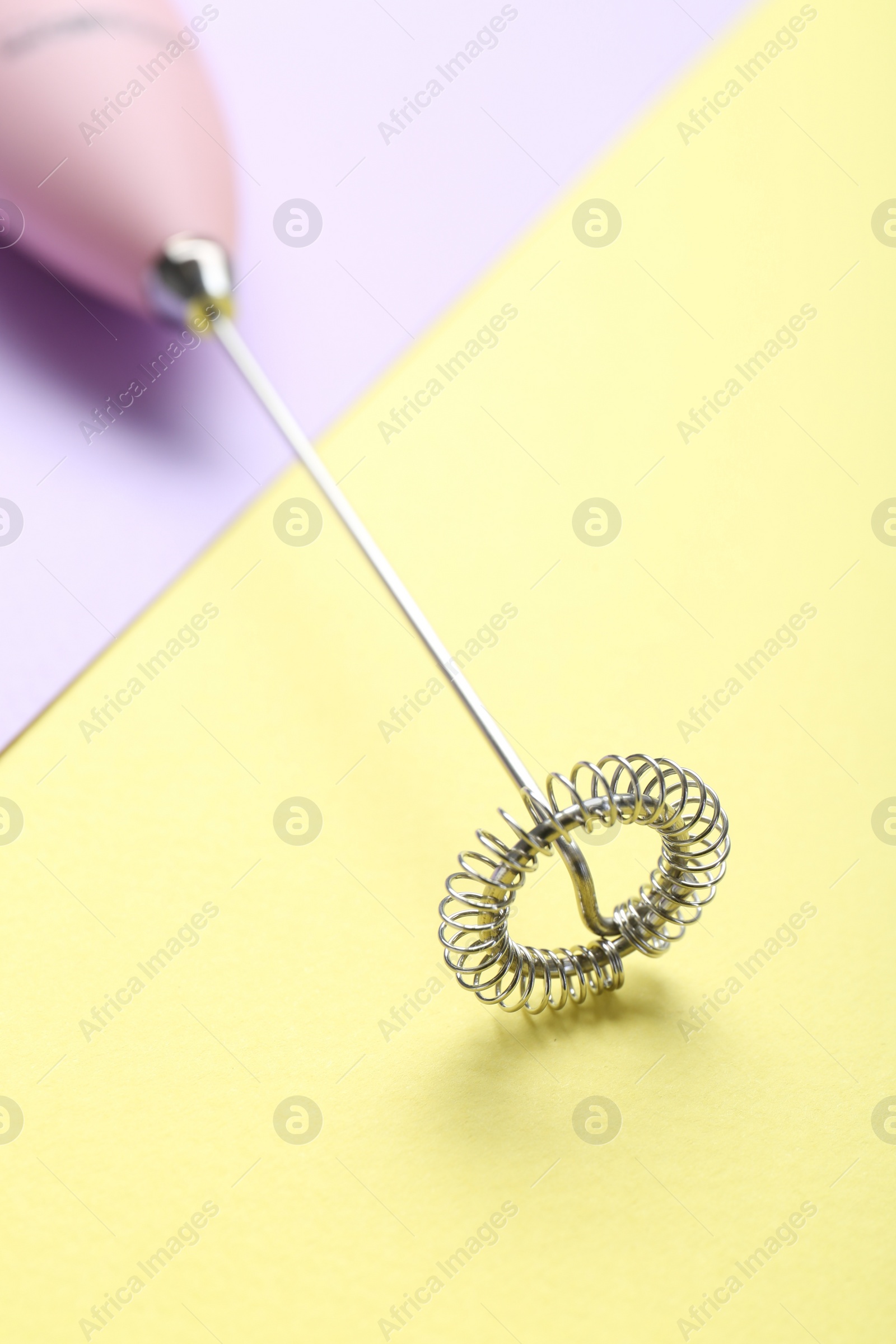 Photo of Pink milk frother wand on color background, closeup