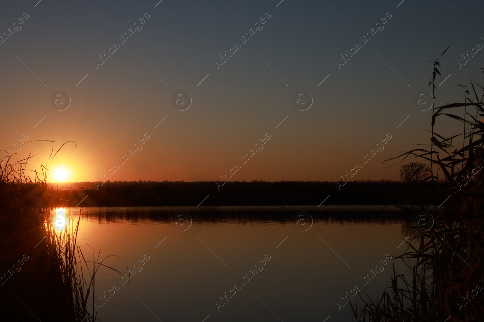 Photo of Picturesque view of tranquil river at sunset