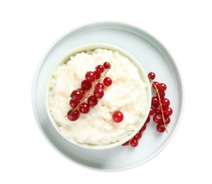 Photo of Creamy rice pudding with red currant in bowl on white background, top view