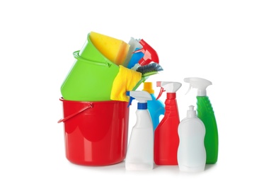 Plastic buckets and different cleaning supplies on white background